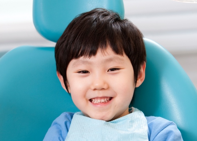 Young boy smiling while visiting childrens dentist in Bedford