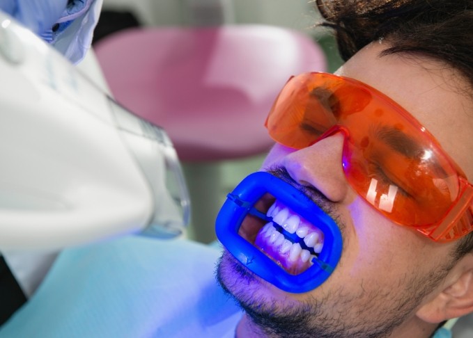 Man getting professional teeth whitening from cosmetic dentist in Bedford