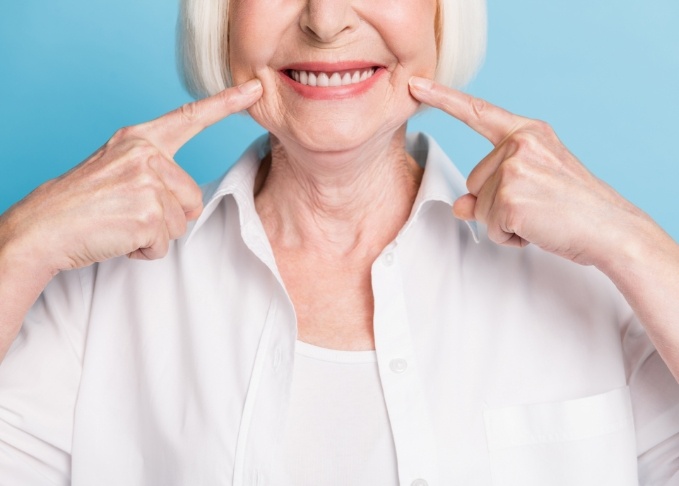 Senior woman pointing to her smile