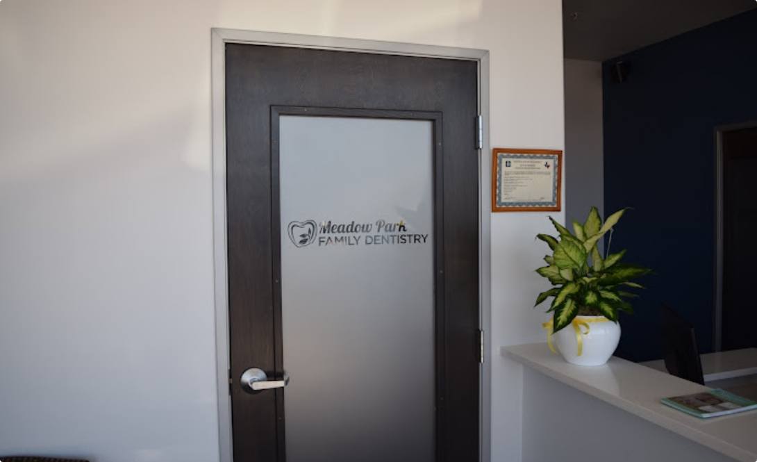 Meadow Park Family Dentistry sign on door of Bedford dental office