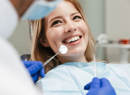 Lady smiles at dentist